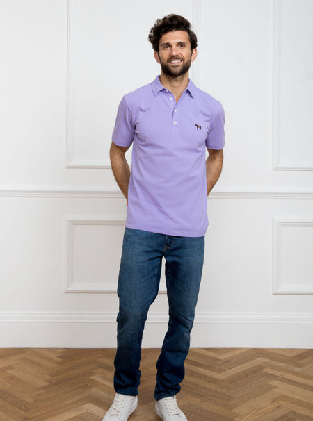 Man wearing lilac polo shirt in 100% cotton with Newmarket 875 horse logo embroidered on the front.